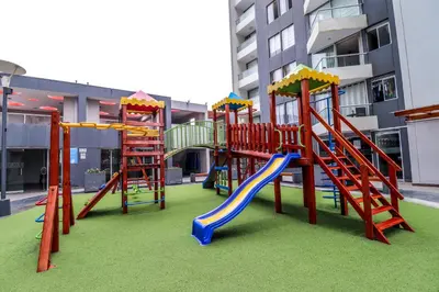 a playground with a slide in a building at Vive y trabaja con estilo en San Miguel, moderno departamento de 2 dorms con balcon in Lima