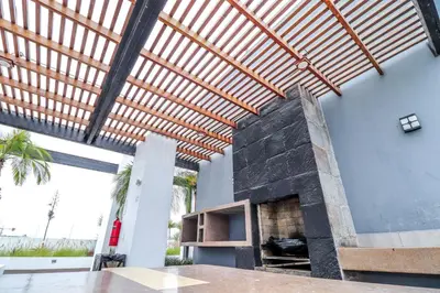 a patio with a stone fireplace in a house at Vive y trabaja con estilo en San Miguel, moderno departamento de 2 dorms con balcon in Lima