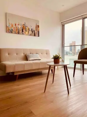 a living room with a couch and a table at Sky1004 in Lima