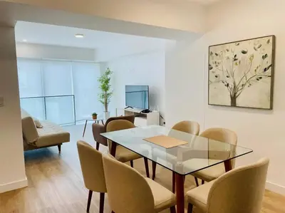 a dining room with a glass table and chairs at Sky1004 in Lima