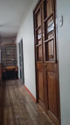an empty hallway with a wooden door in a room at Arcopata Apartamentos in Cusco