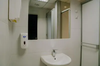 a bathroom with a sink and a mirror at Magar Hostel Bar in Cusco