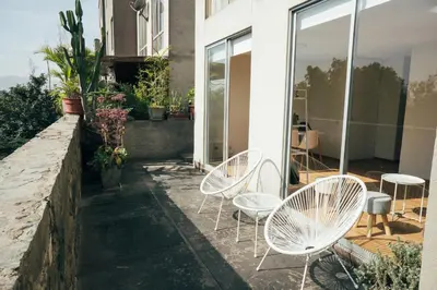 a group of white chairs sitting on a patio at Acogedor departamento con amplia terraza in Lima