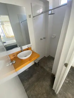 a bathroom with a sink and a mirror at Killamoon House Paracas in Paracas