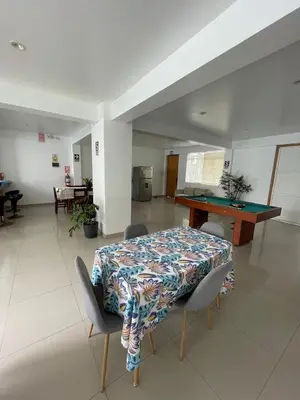 a dining room with a table and a ping pong table at Killamoon House Paracas in Paracas