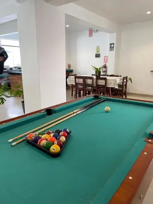 a pool table with balls on it in a room at Killamoon House Paracas in Paracas