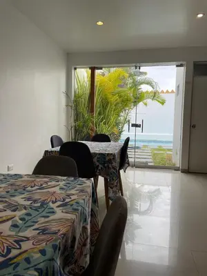 a room with a table and chairs with a view of the ocean at Killamoon House Paracas in Paracas
