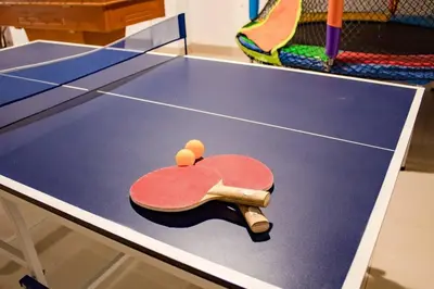 a ping pong table with a racket on it at Amplia Casa de Campo con Piscina en Cieneguilla in Cieneguilla