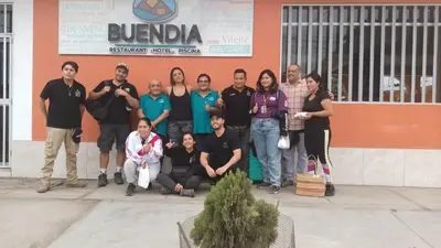 a group of people posing for a picture in front of a building at BUENDIA HOTEL in Pueblo Viejo