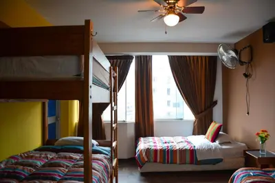 a bedroom with two bunk beds and a window at Tupac Lima Airport in Lima