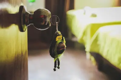 a bird hanging from a door knob in a bedroom at Tupac Lima Airport in Lima