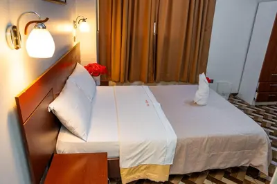 a hotel room with a large bed in a room at Hotel Mayros in Satipo