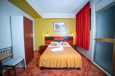 a bedroom with a bed with a swan on it at Hotel Mayros in Satipo