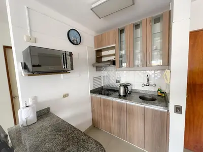 a kitchen with a sink and a clock on the wall at Departamento en el corazón de Miraflores in Lima
