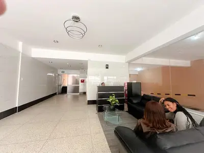 two women sitting on couches in a living room at Departamento en el corazón de Miraflores in Lima