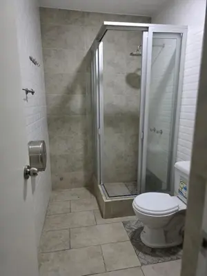 a bathroom with a shower and a toilet at Casa sabina nuevo aeropuerto in Lima