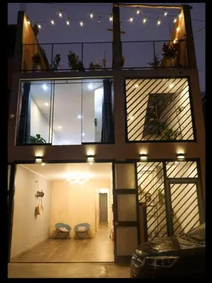 a three story building with two stools on the balcony at Casa sabina nuevo aeropuerto in Lima