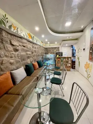 a room with a couch and a table and chairs at Casa Justina in Cusco