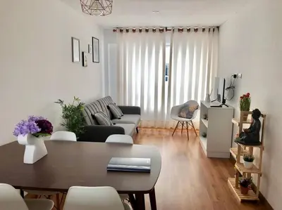 a living room with a couch and a table at Hermoso y amplio departamento en zona tranquila en Jesús Maria in Lima