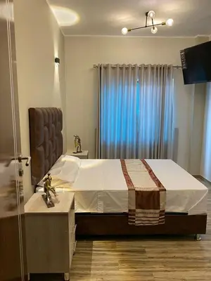 a bedroom with a large bed with a blue window at Ciudad Del Sol Hostel in Ica