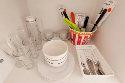 a white counter with a cup and some utensils at Hermoso Penthouse con jacuzzi en terraza in Lima
