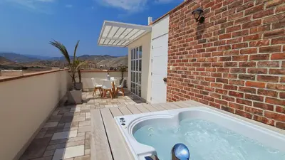 a hot tub on the patio of a house at Hermoso Penthouse con jacuzzi en terraza in Lima