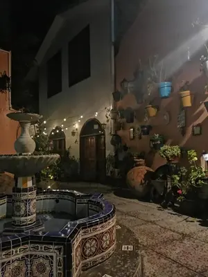 a room with a fountain in front of a building at Hotel Sevilla in Ayacucho