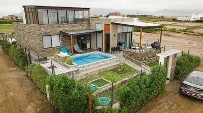a house with a swimming pool in front of it at Mar y campo Casa Huarca in La Isla