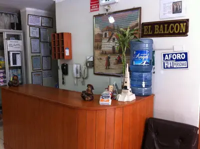 a reception counter in a store with a large blue barrel at El Balcon Hostal in Ayacucho