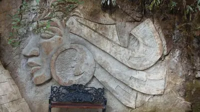 a stone wall with a bench in front at Hostal Pablo's House in Machu Picchu