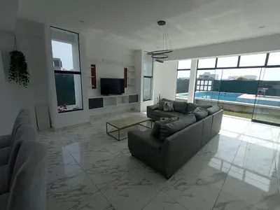 a living room with two couches and a television at Alquilo Casa playa in San Antonio