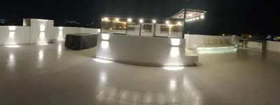 a large white room with lights on it at night at Alquilo Casa playa in San Antonio