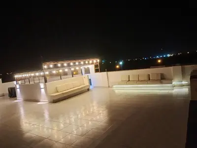 a patio with couches and lights at night at Alquilo Casa playa in San Antonio