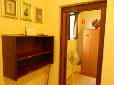 a kitchen with a cabinet and a refrigerator in a room at Kanata Properties 2 in Lima
