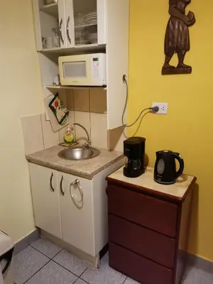 a small kitchen with a sink and a microwave at Kanata Properties 2 in Lima