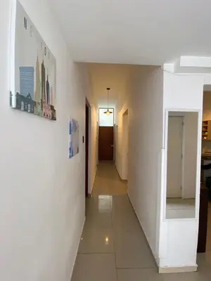 a hallway of a room with white walls and tile floors at Lince Apartments in Lima