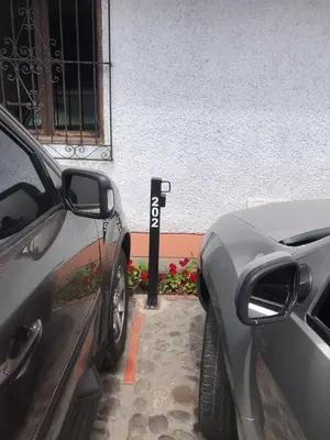 two cars are parked next to a parking meter at Luxury Apartment Barranco Malecon in Lima