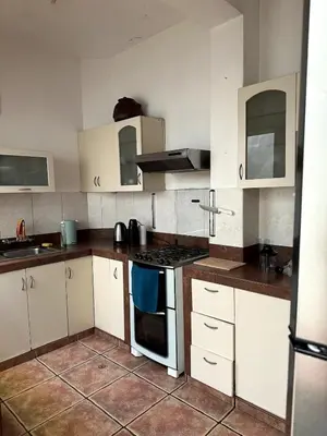 a kitchen with white cabinets and a stove top oven at Casa Huaca in Lima