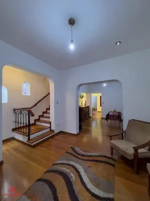 a living room with a couch and a staircase at Casa Huaca in Lima