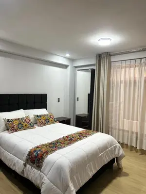 a bedroom with a large bed and a window at Skyhousecusco in Cusco