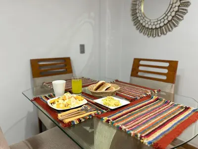 a glass table with plates of food on it at Skyhousecusco in Cusco