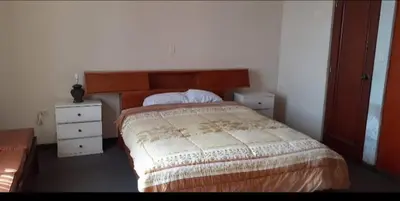 a bedroom with a bed and two night stands at Alojamiento Punta Negra in Punta Negra