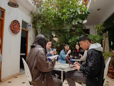 a group of people sitting around a table at Hotel San Francisco de Paula Ayacucho in Ayacucho