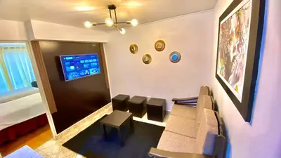 a living room with a couch and chairs and a tv at Apartamento Andahuaylas in Andahuaylas