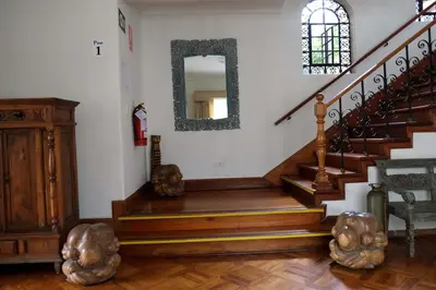 a staircase in a house with a mirror at Inkawasi Miraflores Hostel in Lima