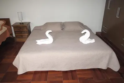 a bed with two swans on top of it at Inkawasi Miraflores Hostel in Lima