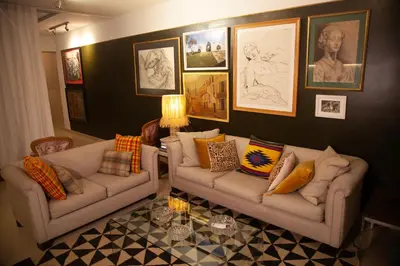 a living room with two couches and pictures on the wall at Chic Miraflores AC HEATER 16th floor in Lima