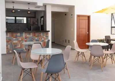 a group of tables and chairs in a room at Hotel Precursores in Lima