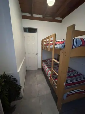 a room with two bunk beds and a door at Playa Arica Backpackers in Arica