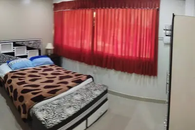 a bedroom with a bed and a red curtain at Depawanka 2 in Huancayo